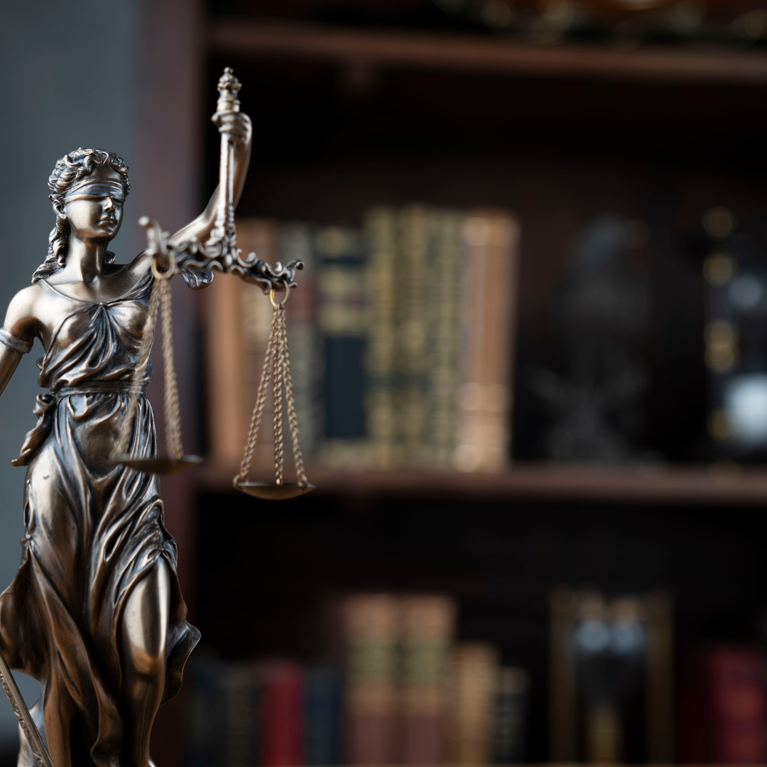 Statue of Lady Justice with law books
